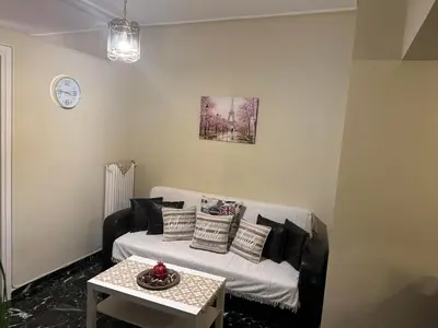 a living room with a couch and a table at Alex Apartment in Athens