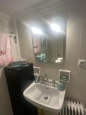 a bathroom with a sink and a mirror at Alex Apartment in Athens
