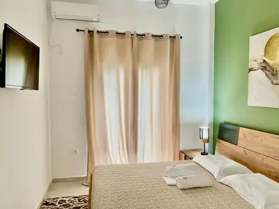 a bedroom with a bed and a shower curtain at Athens nice apartment in Athens