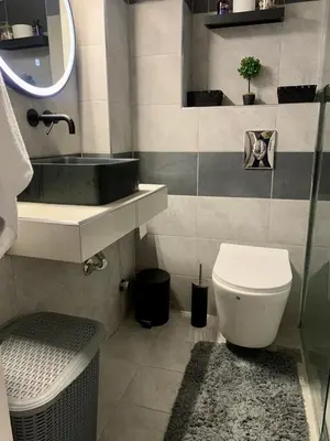 a bathroom with a sink and a toilet and a mirror at Athens nice apartment in Athens