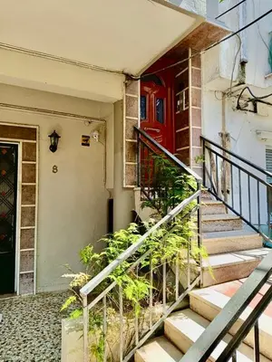 a red door on a house with a staircase at Athens nice apartment in Athens