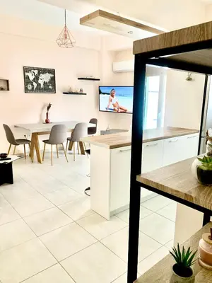 a kitchen and dining room with a table and a tv at Athens nice apartment in Athens