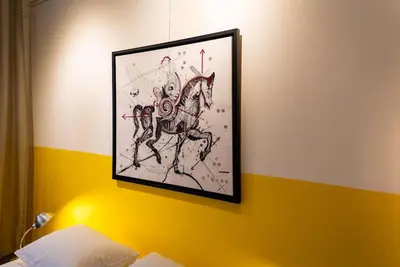 a painting of a horse hanging on a wall at Artistic Spacious Studio Apartment next to metro Monastiraki in Athens