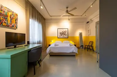 a bedroom with a bed and a flat screen tv at Artistic Spacious Studio Apartment next to metro Monastiraki in Athens