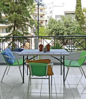 a table and chairs sitting on a balcony at Cozy studio Maria in Paleo Faliro in Athens