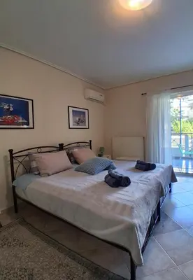 a bedroom with a large bed in a room at Cozy studio Maria in Paleo Faliro in Athens