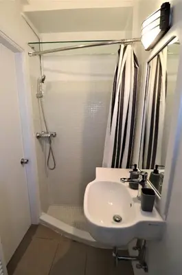 a bathroom with a sink and a shower at Stunning view private terrace studio @Panormou Metro. in Athens