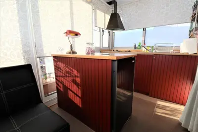 a kitchen with a red counter with a lamp on it at Stunning view private terrace studio @Panormou Metro. in Athens