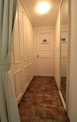 a hallway with white doors and a tile floor at Stunning view private terrace studio @Panormou Metro. in Athens