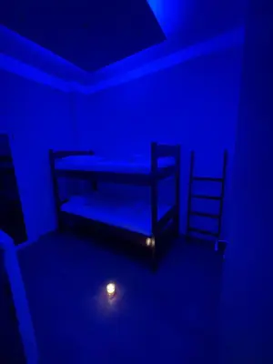 a room with two bunk beds in a blue room at The Sandbox in Athens