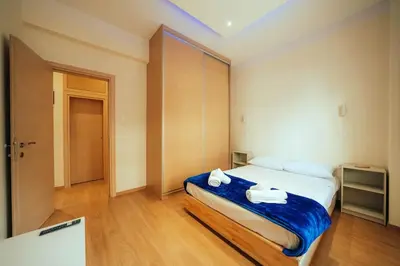 a bedroom with a bed with towels on it at The Sandbox in Athens