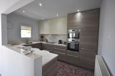 a kitchen with stainless steel appliances and a counter at VillaVita Modern 3BR,Garden & BBQ, Walk to Beach in Kalívia Thorikoú