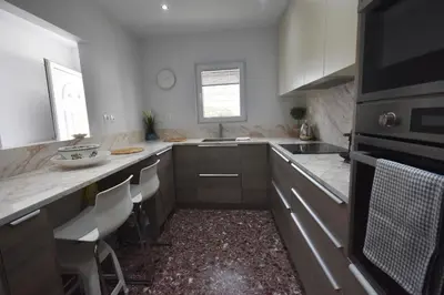 a kitchen with a sink and a counter top at VillaVita Modern 3BR,Garden & BBQ, Walk to Beach in Kalívia Thorikoú
