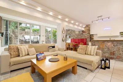 a living room with a couch and a table at Efi's DreamSpace in Athens