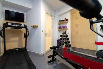 a room with a gym with a treadmill at Efi's DreamSpace in Athens