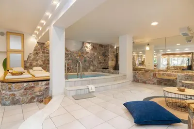 a large bathroom with a tub and a table at Efi's DreamSpace in Athens