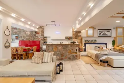a large living room with two beds and a kitchen at Efi's DreamSpace in Athens