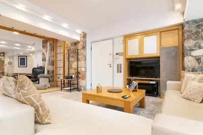 a living room with a white couch and a table at Efi's DreamSpace in Athens