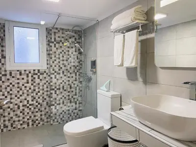 a white bathroom with a sink and a toilet at Uoohome7 garden green and navy in Athens
