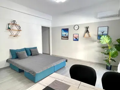 a bedroom with a blue bed in a room at Uoohome7 garden green and navy in Athens