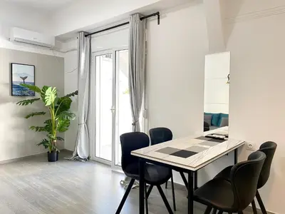 a dining room with a table and chairs at Uoohome7 garden green and navy in Athens