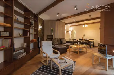 a living room with a couch and a table at Kalista apartment Airport by Airstay in Spáta