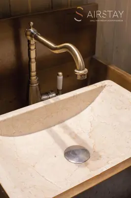 a marble sink with a faucet in a bathroom at Kalista apartment Airport by Airstay in Spáta