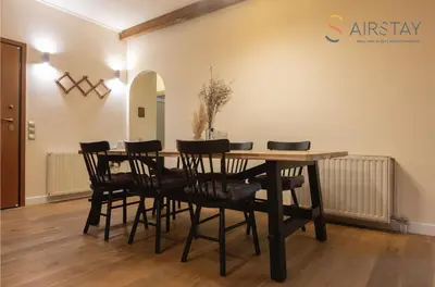 a dining room with a table and chairs at Kalista apartment Airport by Airstay in Spáta