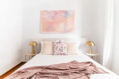 a bedroom with a bed with a blanket on it at Oasis Architect's Dream Neoclassical House next to Acropolis in Athens