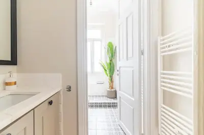 a kitchen with a white door and a potted plant at Oasis Architect's Dream Neoclassical House next to Acropolis in Athens
