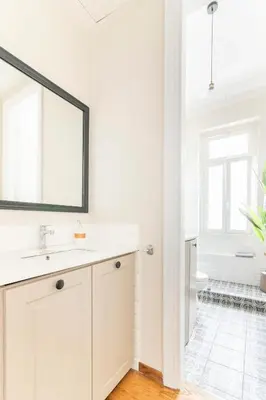 a white bathroom with a sink and a mirror at Oasis Architect's Dream Neoclassical House next to Acropolis in Athens