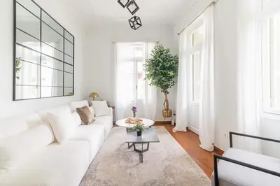 a white living room with a white couch and a table at Oasis Architect's Dream Neoclassical House next to Acropolis in Athens