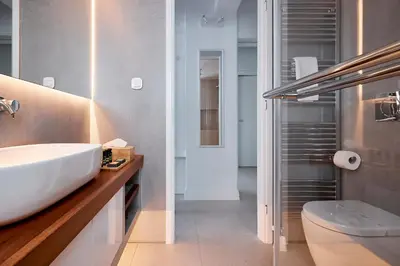 a bathroom with a sink and a toilet at Elaia Luxury Selections Opal in Athens