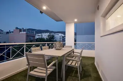 a table and chairs on a balcony with a view at Elaia Luxury Selections Opal in Athens