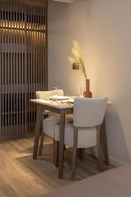a dining room table with two white chairs and a wooden table at 507 Athens in Athens