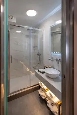 a bathroom with a glass shower and a sink at 507 Athens in Athens