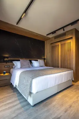 a bedroom with a large white bed with a black headboard at 507 Athens in Athens