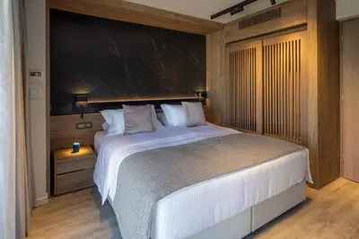 a bedroom with a large bed with a black wall at 507 Athens in Athens