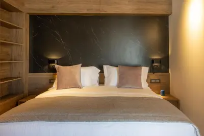 a bedroom with a large bed with a black headboard at 507 Athens in Athens