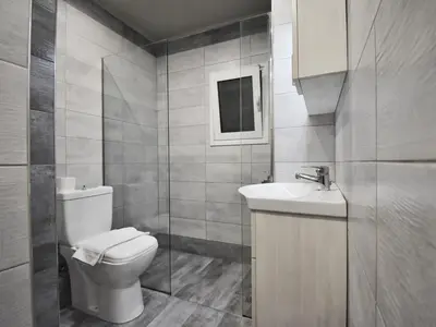 a bathroom with a toilet and a sink at Petite Apartment in Athens