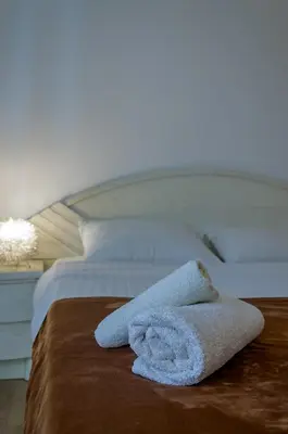 a towel sitting on top of a bed at Nice 1BD apartment close to metro station Ampelokipoi in Athens