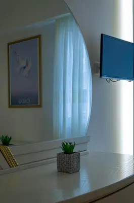 a room with a window and a table with a plant at Nice 1BD apartment close to metro station Ampelokipoi in Athens