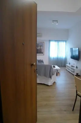an open door to a bedroom with a bed at Nice 1BD apartment close to metro station Ampelokipoi in Athens