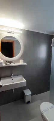 a bathroom with a sink and a mirror at Poseidonio in Piraeus
