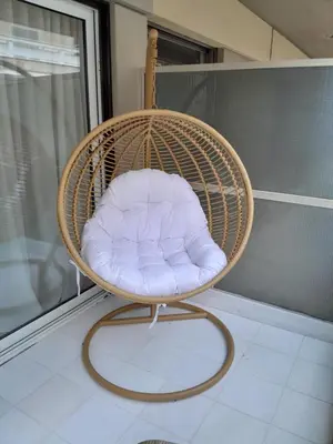a wicker chair with a white pillow in a room at Kolonaki Upscale 4 bedroom Luxury Apartment in Athens