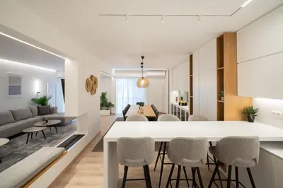 a kitchen and living room with a table and chairs at Kolonaki Upscale 4 bedroom Luxury Apartment in Athens