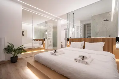a bedroom with a large white bed with two towels on it at Kolonaki Upscale 4 bedroom Luxury Apartment in Athens