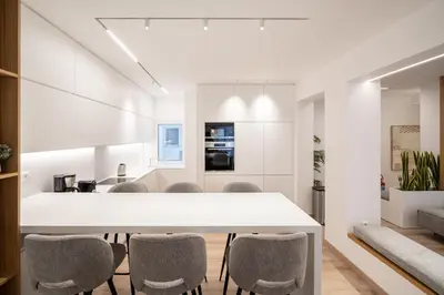 a kitchen and dining room with a white table and chairs at Kolonaki Upscale 4 bedroom Luxury Apartment in Athens
