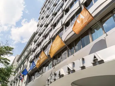 a building with flags on the side of it at Titania Hotel in Athens