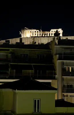 a white building with lights on top of it at night at Hera Hotel in Athens